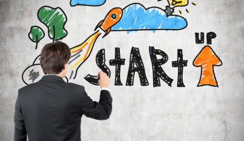 businessman drawing startup concept on concrete wall